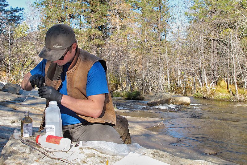 Sampling river water to measure oxygen content